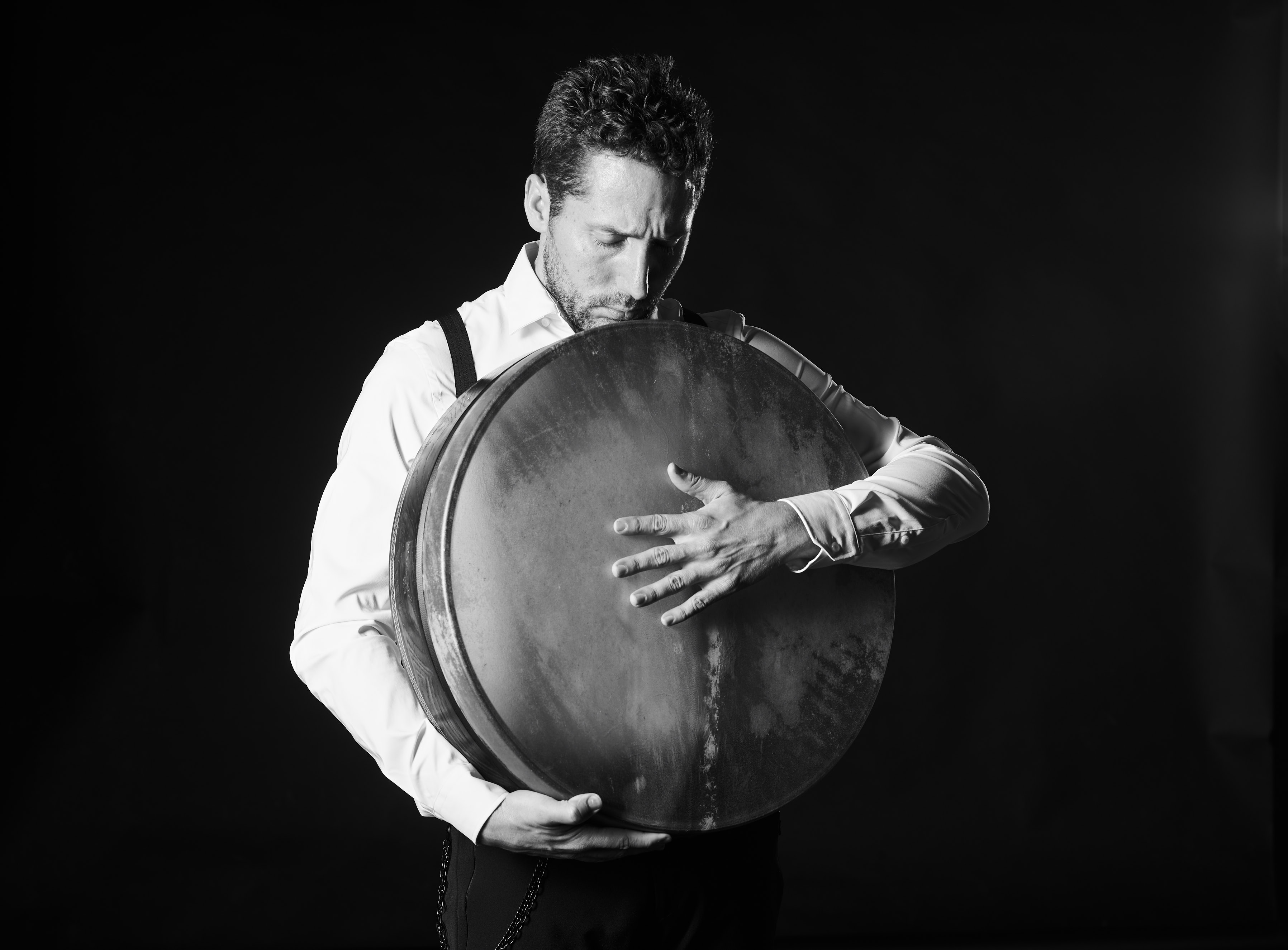 Yshai Afterman with a large frame drum held in front of his body