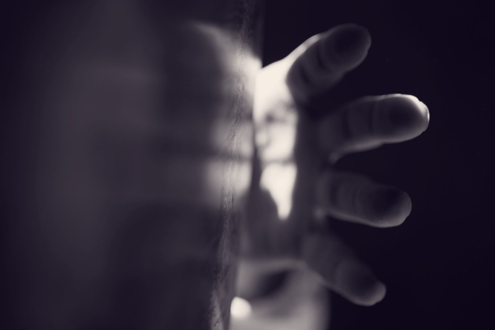A hand reaching for the edge of a frame drum